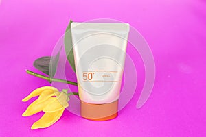 Natural cosmetic sunsceen spf50 with ylang flower on pink