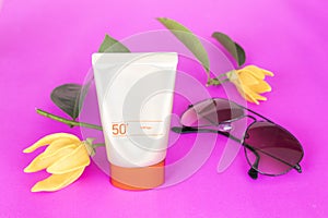 Natural cosmetic sunsceen spf50 with ylang flower on pink