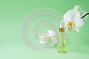 Natural cosmetics anti-aging, anti-wrinkle, for youth, skin elasticity on green background. cream, mask in jar, serum, fluid, oil