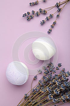 Natural cosmetics. Handmade lavender bath bombs and lavender flowers on purple background