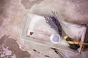 Natural cosmetics. Handmade lavender bath bombs, lavender flowers and towel on white wooden planks, top view