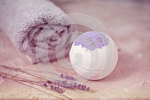 Natural cosmetics. Handmade lavender bath bombs, lavender flowers and towel on white wooden planks, top view