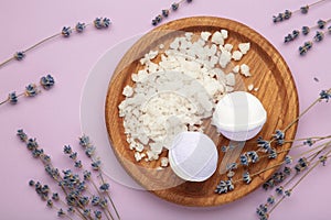 Natural cosmetics. Handmade lavender bath bombs and lavender flowers on wooden board on purple background