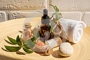 Natural cosmetics set in eco-friendly packaging in bamboo plate with cotton towel. SPA, bath beauty products