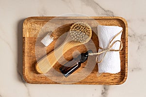 Natural cosmetics set in eco-friendly packaging in wooden tray with sea salt and towel. SPA, bath beauty products