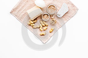 Natural cosmetics for skin care. Body scrub with peanut. White background top view copy space