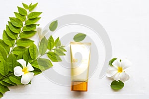 Natural cosmetics sunscreen spf50 health care for skin face with flowers frangipani ,leaf of lifestyle woman