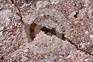 Natural crack in conglomerate rock layer photo