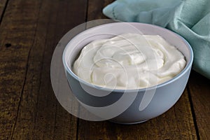 Natural creamy Greek yoghurt on wooden table background with spa