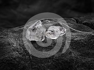 Natural diamond nestled on black coal background