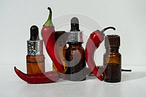 Natural essential oil with chili pepper additives. Essential oil of red pepper.