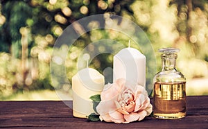 Natural essential oil, fragrant roses and candles. Spa concept. Romantic concept. Copy space