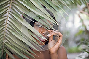 Natural exotic beauty, wellness. Close up portrait of smiling pretty mysterious African woman model, posing to camera