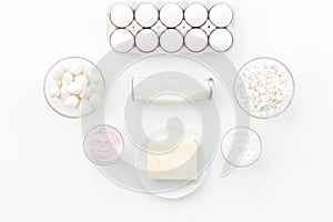 Natural farm products. Milk, cottage, eggs, cheese, yougurt on white background top view. Monochrome