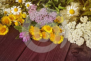 Natural floral background, a bouquet of wild flowers on a wooden table