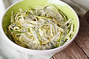 Natural food: raw zucchini pasta in a bowl closeup. horizontal