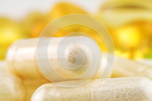 Natural food supplement pills, glucosamine and omega 3 capsules, macro image.