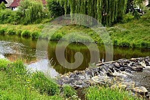 Natural stone dam on the river photo