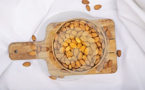 Natural fresh almonds on kitcken table with white background photo