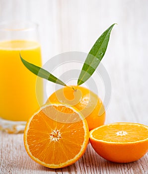 Natural fresh fruit oranges in a wooden background backdrop, half cut oranges, orange juice, vitamin C, for good health everyday