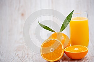 Natural fresh fruit oranges in a wooden background backdrop, half cut oranges, orange juice, vitamin C, for good health everyday