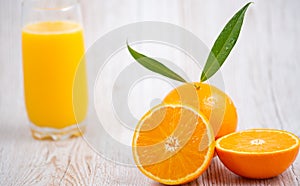 Natural fresh fruit oranges in a wooden background backdrop, half cut oranges, orange juice, vitamin C, for good health everyday