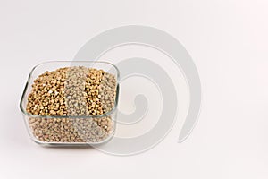 Natural fresh green buckwheat in g lass bowl isolated on white