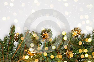 Natural fresh green pine christmas tree branches with bokeh lights background