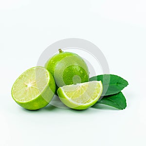 Natural fresh lime, green leaf and sliced with water drops isolated on white background