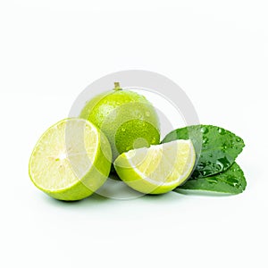 Natural fresh lime, green leaf and sliced with water drops isolated on white background