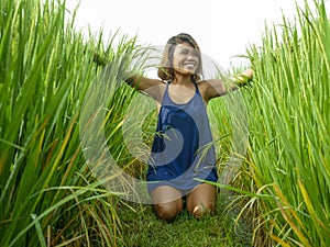Natural and fresh portrait of young happy and exotic islander Asian girl from Indonesia smiling cheerful and excited posing in