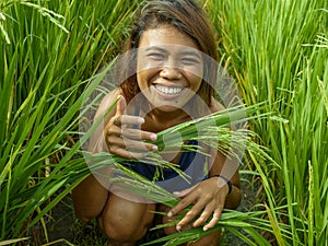 Natural and fresh portrait of young happy and exotic islander Asian girl from Indonesia smiling cheerful and excited posing in