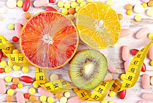 Natural fruits, centimeter and medical pills, slimming, choice between healthy nutrition and medical supplements