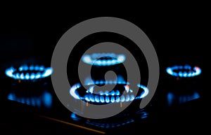 Natural gas burning, blue flames on black background