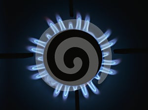 Natural gas burning a blue flames on black background