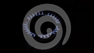 Natural gas burning a blue flames on black background. video 4 k. gas outage. the increase in gas prices leads to its closure.