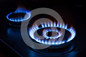 Natural gas burning on the stove. Blue flame. Two burners.