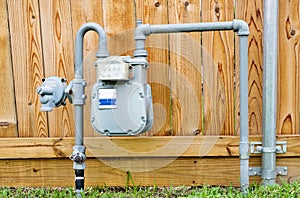 Natural gas meter in residential suburban backyard.