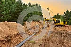 Natural Gas Pipeline Construction. Building of transit petrochemical pipe in forest area.