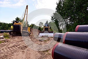 Natural gas pipeline construction work. Crawler crane with side boom Pipelayer Installation of  gas and crude oil pipes in ground