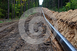 Natural gas pipeline construction work. A dug trench in the ground for the installation and installation of industrial gas