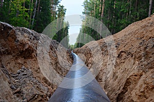 Natural gas pipeline construction work. A dug trench in the ground for the installation and installation of industrial gas and oil