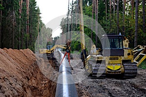 Natural gas pipeline construction work. A dug trench in the ground for the installation and installation of industrial gas and oil