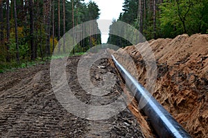 Natural gas pipeline construction work. A dug trench in the ground for the installation and installation of industrial gas and oil