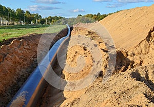 Natural gas pipeline construction work. A dug trench in the ground for the installation and installation of industrial gas and oil