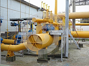 Natural gas station with yellow pipes power plant