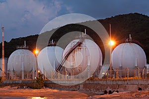 Natural gas storage tank in sphere shape at twilight time photo