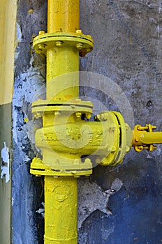 Natural gas valve painted in yellow color, closeup