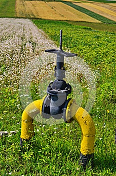 Natural gas valve painted in yellow color, closeup