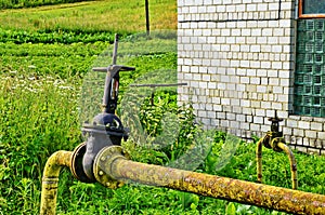 Natural gas valve painted in yellow color, closeup